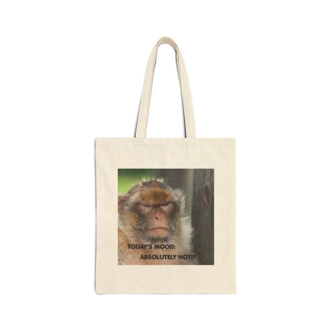 A tote bag featuring a close-up of a monkey's face with text overlay.
